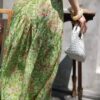 Curved pleated ramie skirt with green grass and flowers