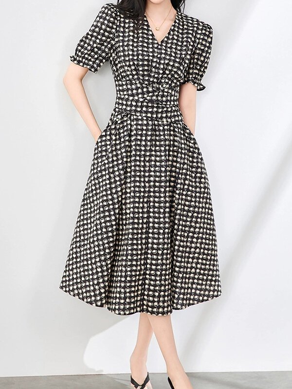 Architectural check shift dress in stonewashed organic cotton, featuring origami-inspired bust darts and geometric patch pockets for functional minimalist workwear.