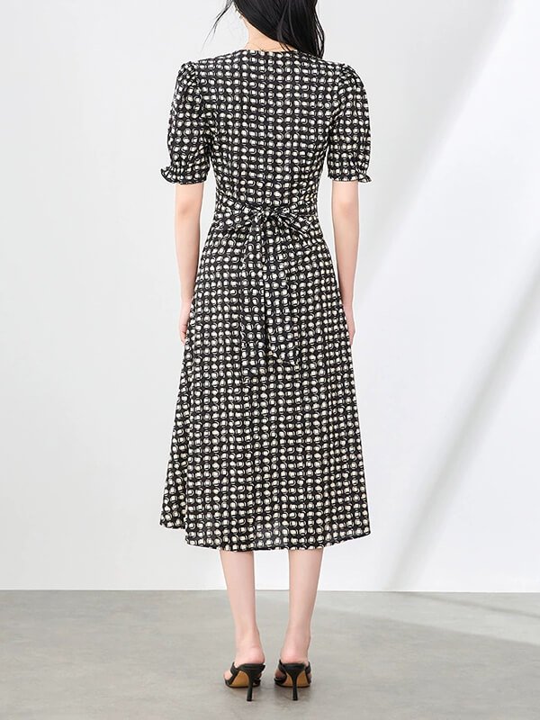 Heirloom-quality checked shirting dress with Victorian-inspired leg-o-mutton sleeves, French seam construction, and convertible Peter Pan collar for vintage-modern offices.